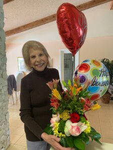Suzanne with birthday balloon and flowers